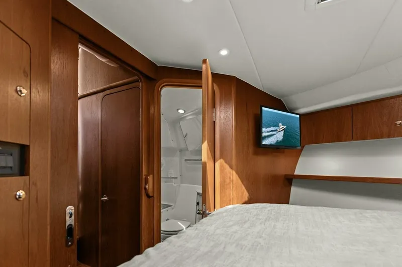 Salty Dach Yacht Photos Pics Interior of 2013 Tiara Yachts 3900 Convertible, featuring wood cabinetry and a mounted TV.