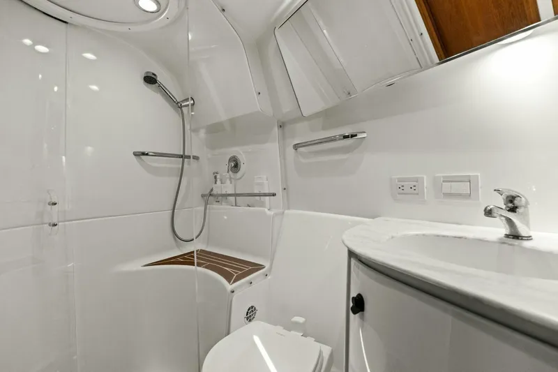 Salty Dach Yacht Photos Pics Luxurious bathroom in 2013 Tiara Yachts 3900 Convertible, featuring modern fixtures and sleek design.