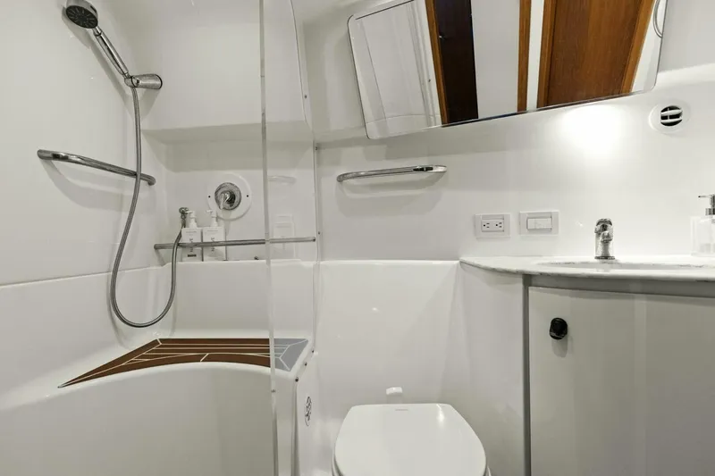 Salty Dach Yacht Photos Pics Luxurious bathroom in 2013 Tiara Yachts 3900 Convertible, featuring modern fixtures and sleek design.