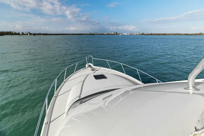 Salty Dach Yacht Photos Pics 2013 Tiara Yachts 3900 Convertible cruising on open water under a clear sky.