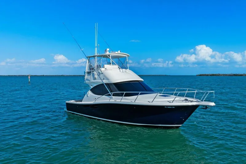 Salty Dach Yacht Photos Pics 2013 Tiara Yachts 3900 Convertible on calm blue waters under clear sky.