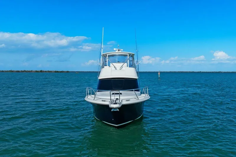 Salty Dach Yacht Photos Pics 2013 Tiara Yachts 3900 Convertible on open water under clear blue sky.