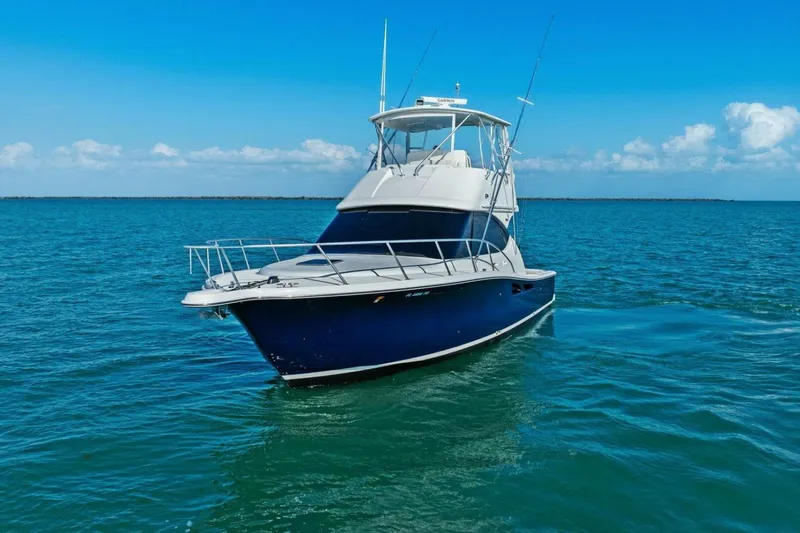 Salty Dach Yacht Photos Pics 2013 Tiara Yachts 3900 Convertible on open water under clear blue sky.