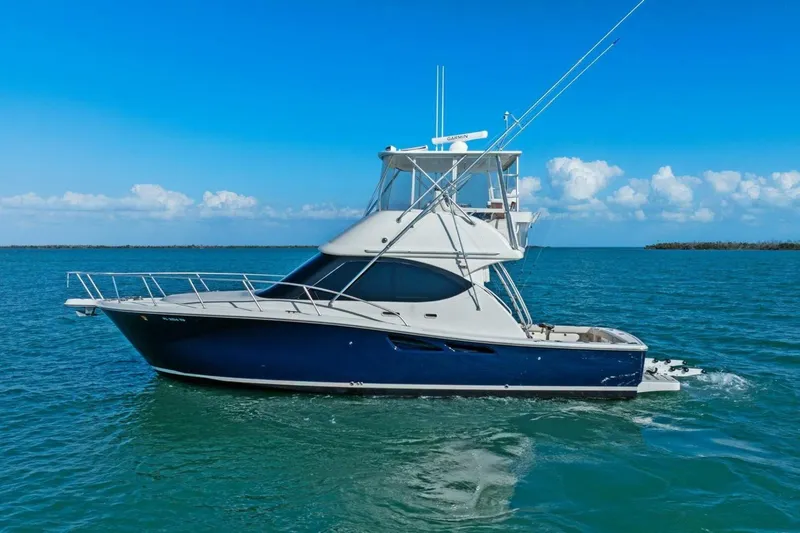 Salty Dach Yacht Photos Pics 2013 Tiara Yachts 3900 Convertible cruising on clear blue waters.