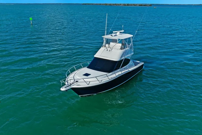 Salty Dach Yacht Photos Pics 2013 Tiara Yachts 3900 Convertible cruising on clear blue waters.