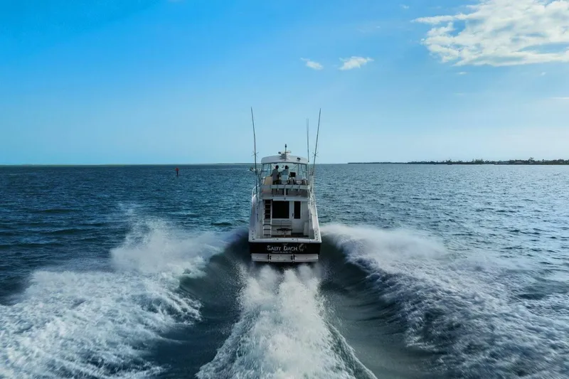 Salty Dach Yacht Photos Pics 2013 Tiara Yachts 3900 Convertible cruising on open water under clear blue sky.