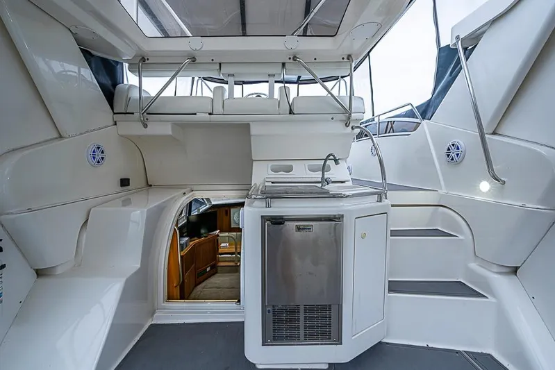 Faintasea Yacht Photos Pics 2000 Silverton 442 Cockpit Motor Yacht interior with kitchenette and seating area.