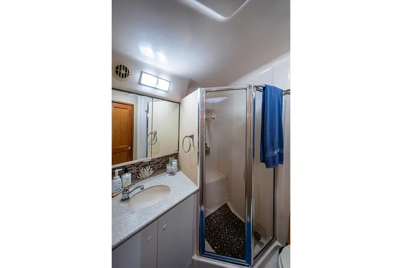 Faintasea Yacht Photos Pics Bathroom interior of 2000 Silverton 442 Cockpit Motor Yacht with shower and sink.