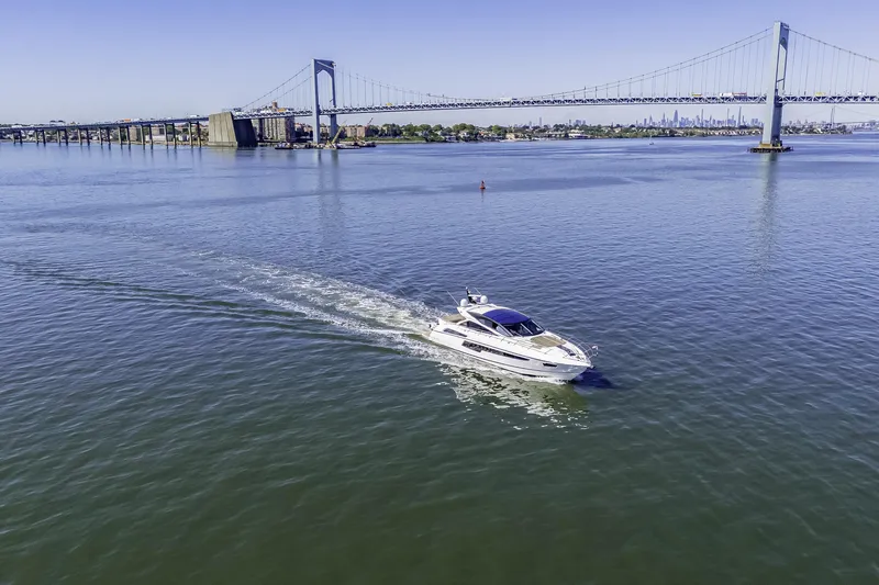  Yacht Photos Pics Sunseeker 68 Sport Yacht cruising near a large suspension bridge, 2014 model.