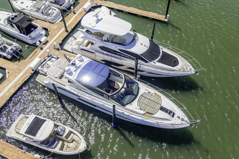  Yacht Photos Pics Aerial view of 2014 Sunseeker 68 Sport Yacht docked among other boats.