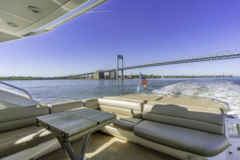  Yacht Photos Pics Luxurious 2014 Sunseeker 68 Sport Yacht cruising under a scenic bridge.
