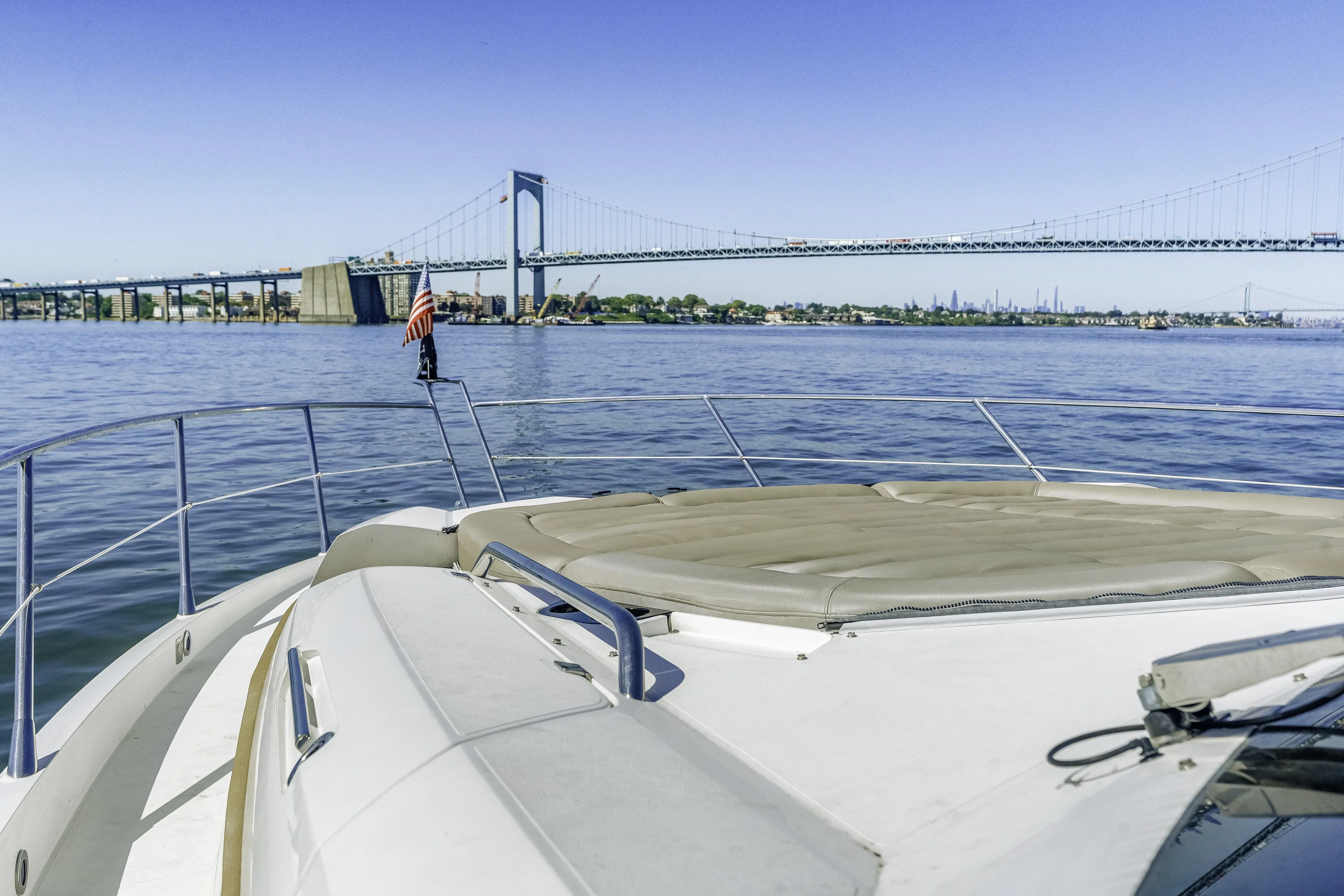  Yacht Photos Pics 2014 Sunseeker 68 Sport Yacht cruising near a bridge on a sunny day.