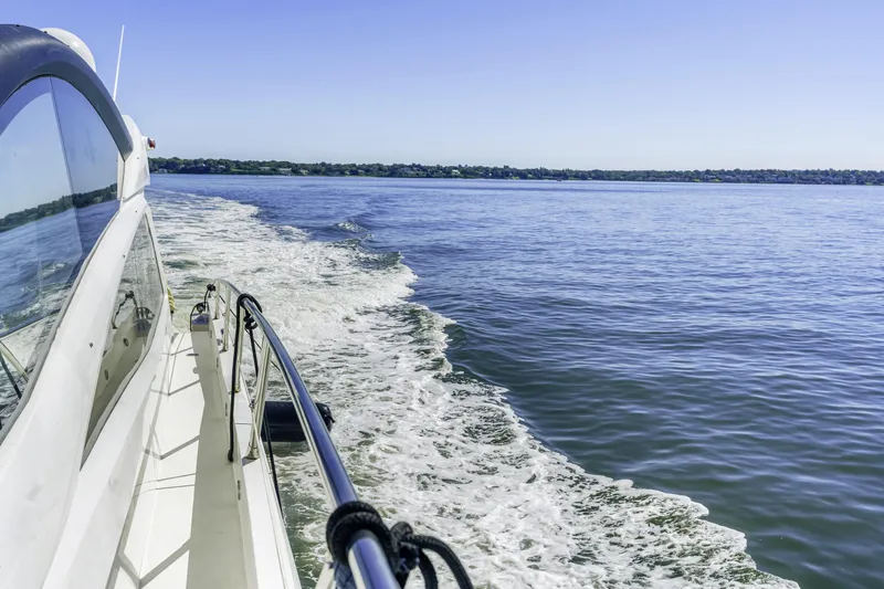  Yacht Photos Pics 2014 Sunseeker 68 Sport Yacht cruising on open water, clear blue sky.