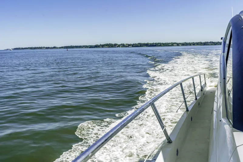  Yacht Photos Pics 2014 Sunseeker 68 Sport Yacht cruising on open water, leaving a wake behind.