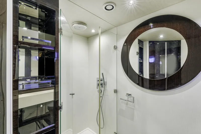  Yacht Photos Pics Luxurious bathroom interior of 2014 Sunseeker 68 Sport Yacht with modern fixtures and round mirror.