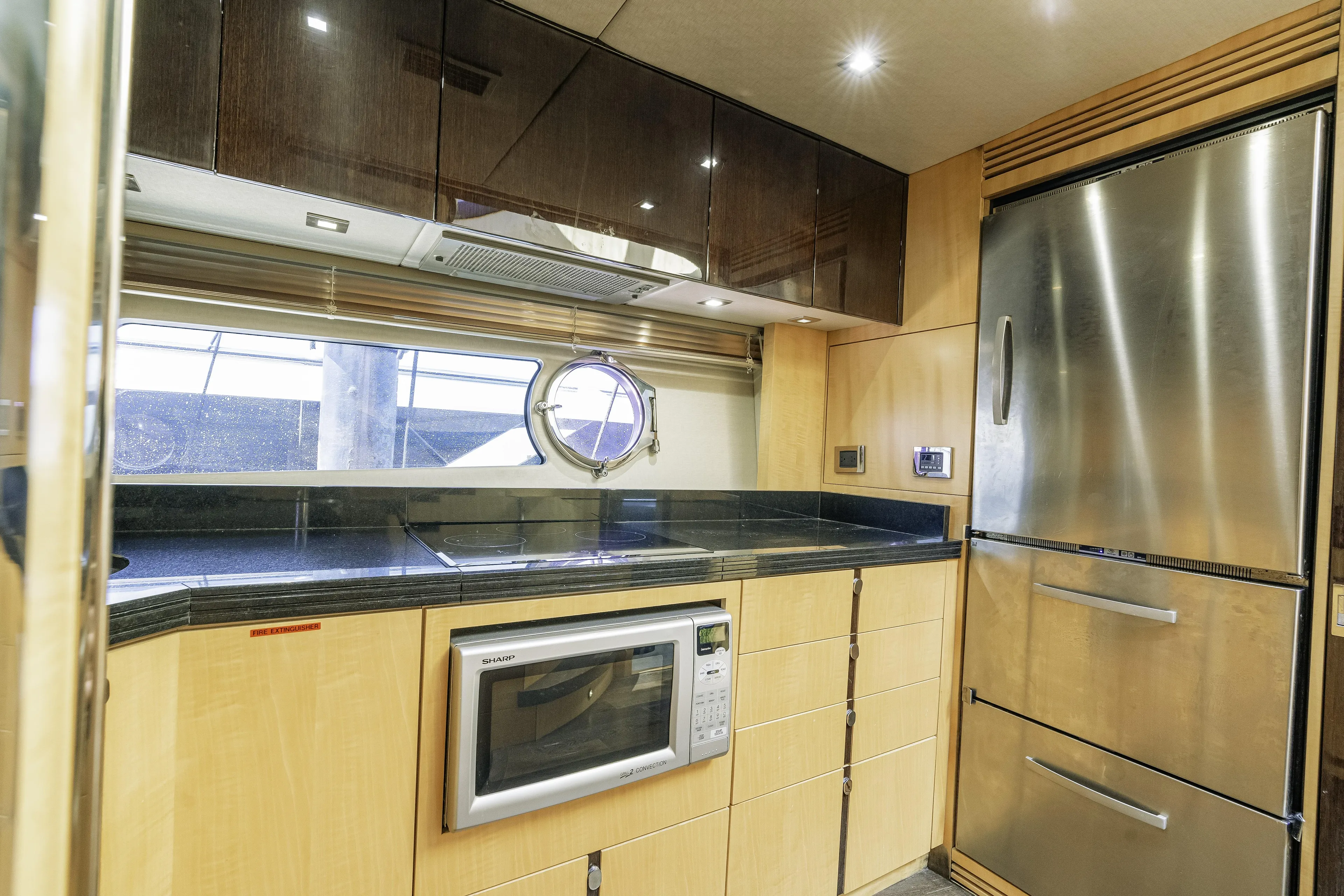  Yacht Photos Pics Modern kitchen interior of 2014 Sunseeker 68 Sport Yacht with stainless steel appliances.