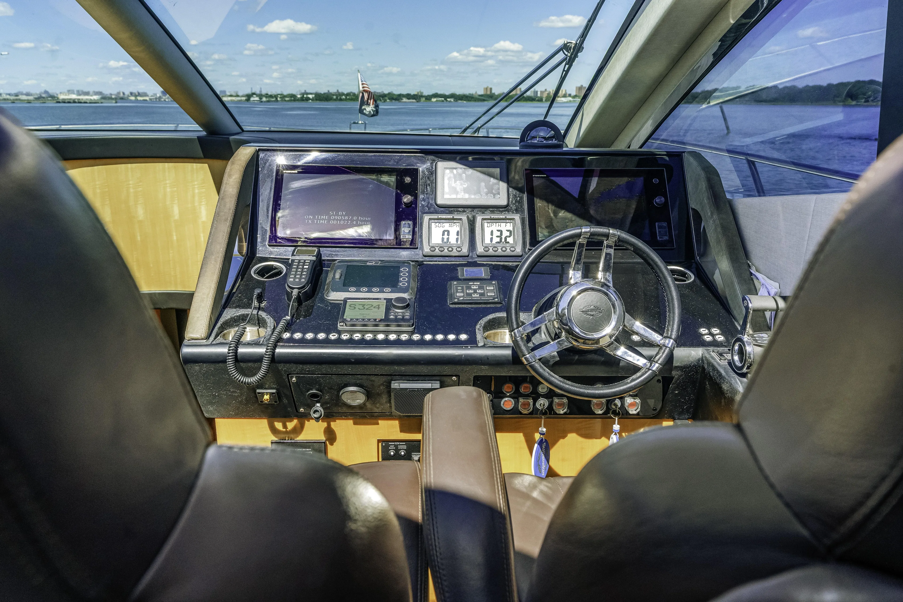  Yacht Photos Pics Cockpit of 2014 Sunseeker 68 Sport Yacht with steering wheel and navigation controls.