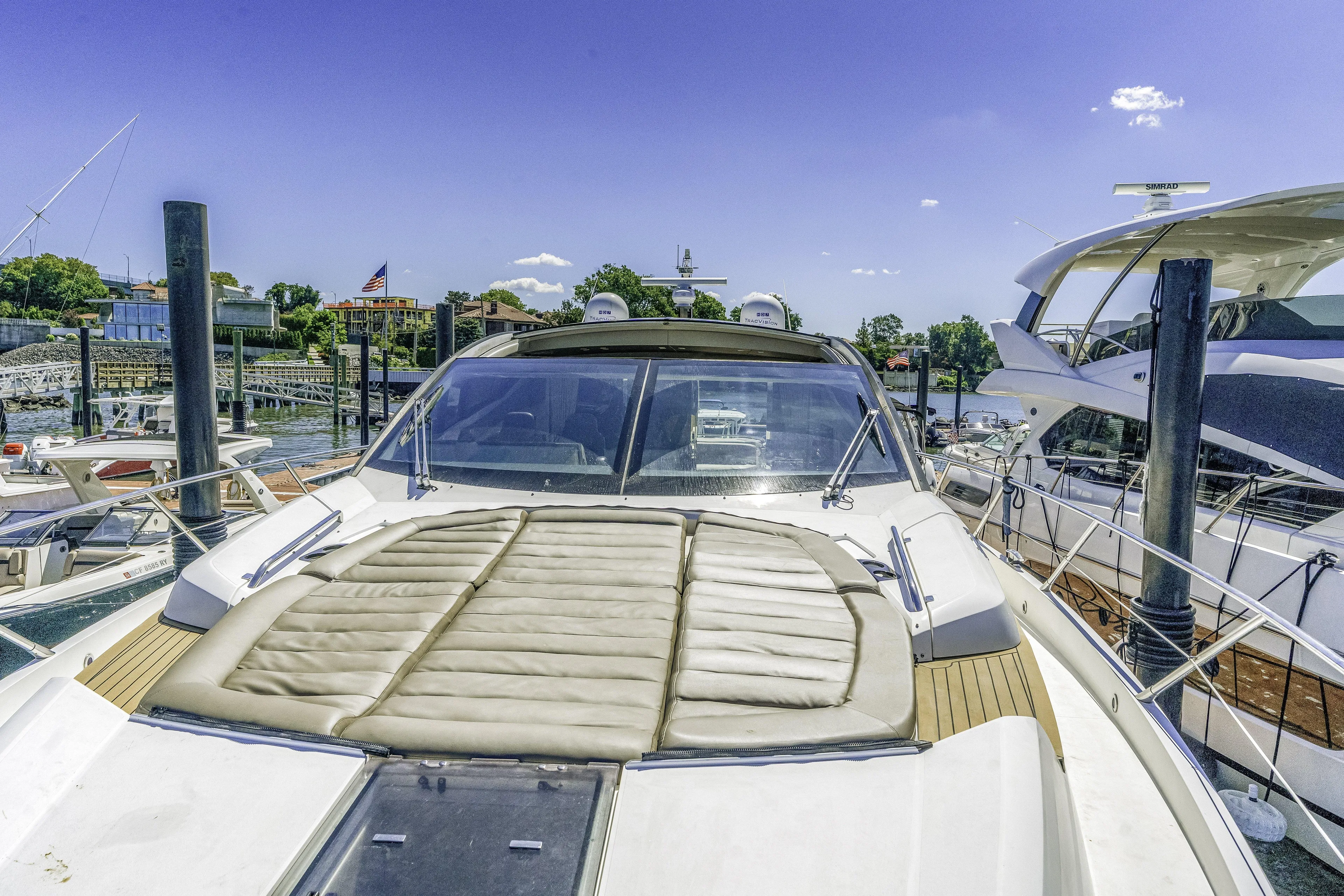 Yacht Photos Pics 2014 Sunseeker 68 Sport Yacht docked at marina under clear blue sky.