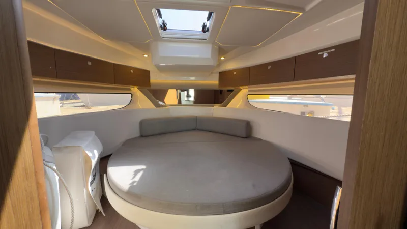  Yacht Photos Pics 2019 Jeanneau NC Weekender 1095 cabin with round bed and skylight.