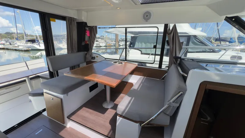  Yacht Photos Pics 2019 Jeanneau NC Weekender 1095 interior with dining area and marina view.