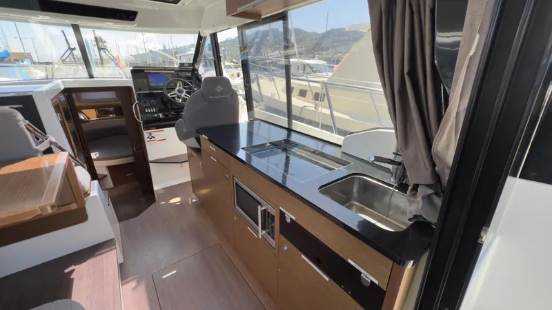  Yacht Photos Pics Interior of 2019 Jeanneau NC Weekender 1095 with modern kitchen and helm station.
