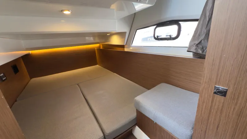  Yacht Photos Pics 2019 Jeanneau NC Weekender 1095 cabin with cozy bed and modern wood finish.