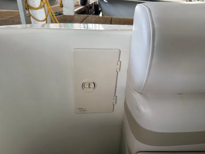 Jet Lag Yacht Photos Pics White interior of 1999 Sea Ray 400 Sedan Bridge with seat and access panel.