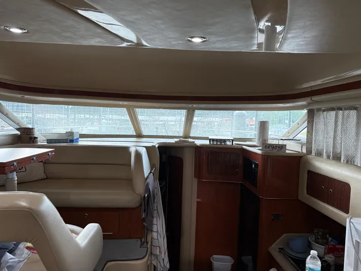 Jet Lag Yacht Photos Pics Interior of 1999 Sea Ray 400 Sedan Bridge yacht with seating and wooden cabinetry.