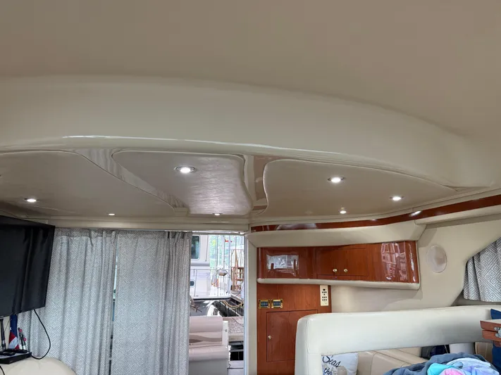 Jet Lag Yacht Photos Pics Interior of 1999 Sea Ray 400 Sedan Bridge with modern lighting and wood cabinetry.