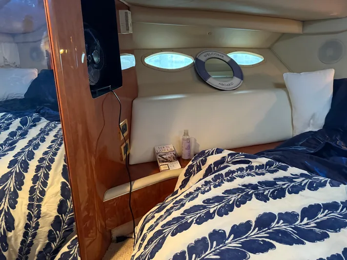 Jet Lag Yacht Photos Pics Cozy cabin interior of 1999 Sea Ray 400 Sedan Bridge with nautical decor and bedding.