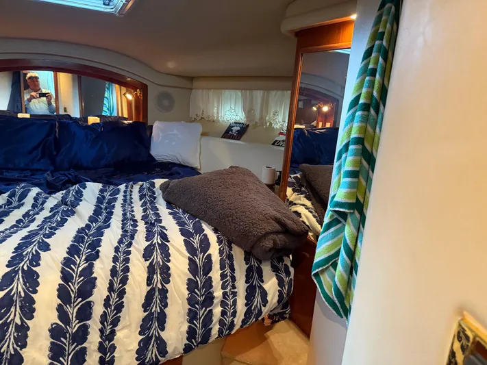 Jet Lag Yacht Photos Pics Cozy bedroom interior of 1999 Sea Ray 400 Sedan Bridge yacht with patterned bedding.