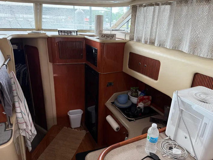 Jet Lag Yacht Photos Pics Interior of 1999 Sea Ray 400 Sedan Bridge yacht with kitchen amenities.