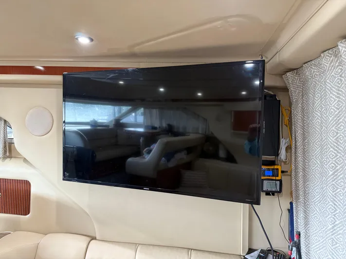 Jet Lag Yacht Photos Pics Interior of 1999 Sea Ray 400 Sedan Bridge with mounted flat-screen TV.