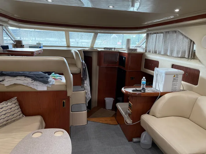 Jet Lag Yacht Photos Pics Interior of a 1999 Sea Ray 400 Sedan Bridge yacht with beige seating and wooden accents.