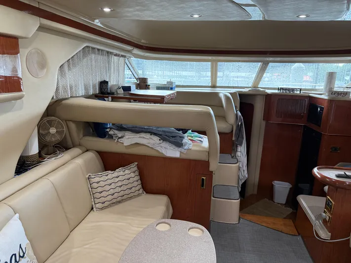 Jet Lag Yacht Photos Pics Interior of a 1999 Sea Ray 400 Sedan Bridge yacht with cozy seating and elegant wood finishes.