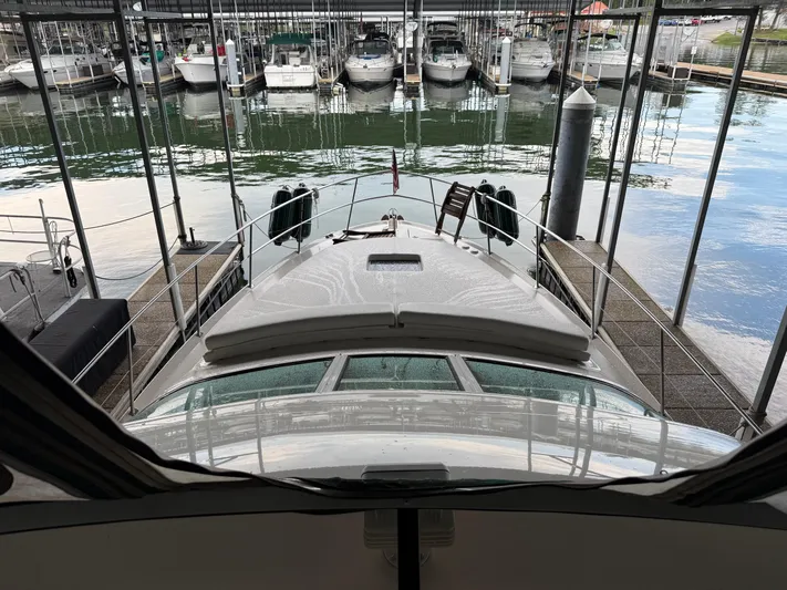 Jet Lag Yacht Photos Pics 1999 Sea Ray 400 Sedan Bridge docked in a marina with multiple boats.