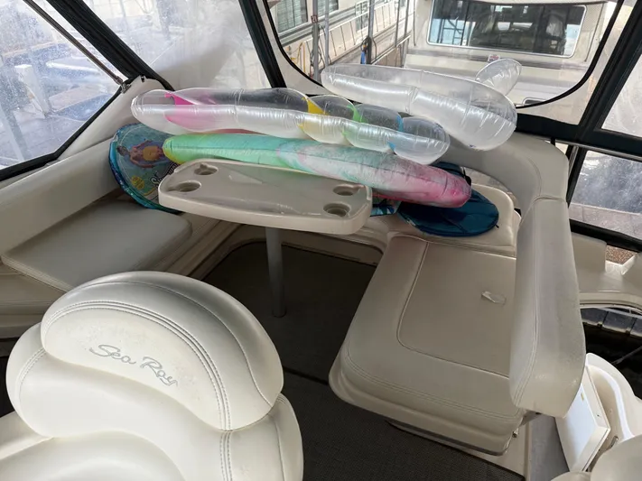 Jet Lag Yacht Photos Pics Interior of 1999 Sea Ray 400 Sedan Bridge with seating and inflatables.