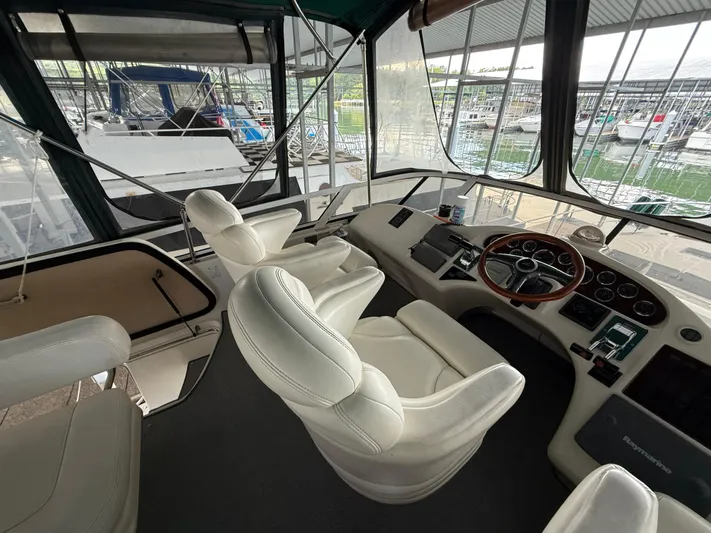 Jet Lag Yacht Photos Pics Interior of 1999 Sea Ray 400 Sedan Bridge yacht with white leather seats and control panel.