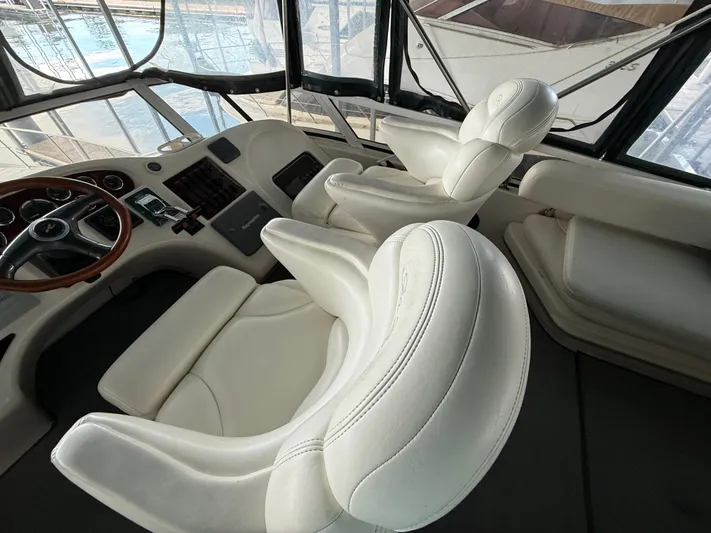 Jet Lag Yacht Photos Pics Luxurious interior of 1999 Sea Ray 400 Sedan Bridge with white leather seating.