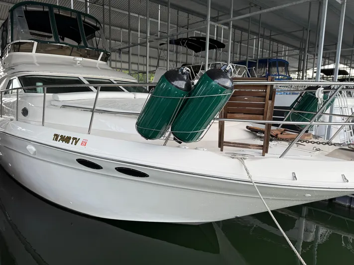 Jet Lag Yacht Photos Pics 1999 Sea Ray 400 Sedan Bridge yacht docked in a covered marina.