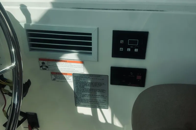 Sister's Yacht Photos Pics Control panel and warning labels on a 2013 Back Cove 30 boat dashboard.