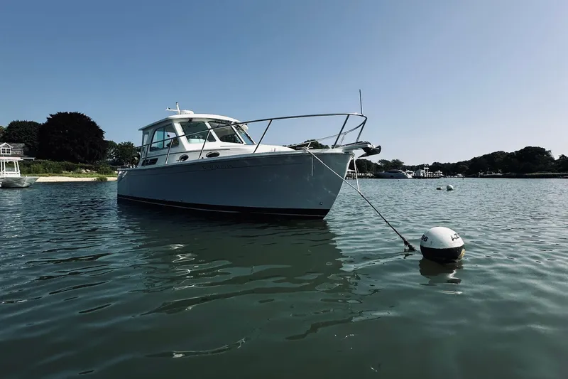 Sister's Yacht Photos Pics 2013 Back Cove 30 boat moored in calm waters on a sunny day.