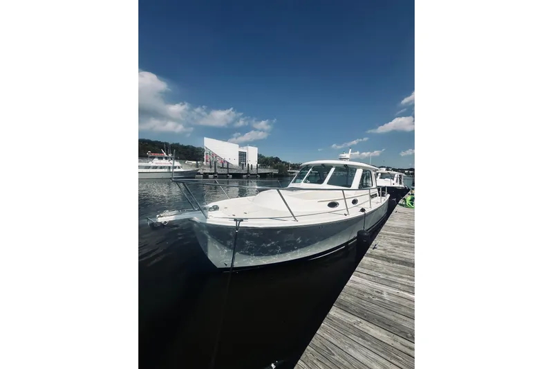 Sister's Yacht Photos Pics 2013 Back Cove 30 boat docked under a clear blue sky.