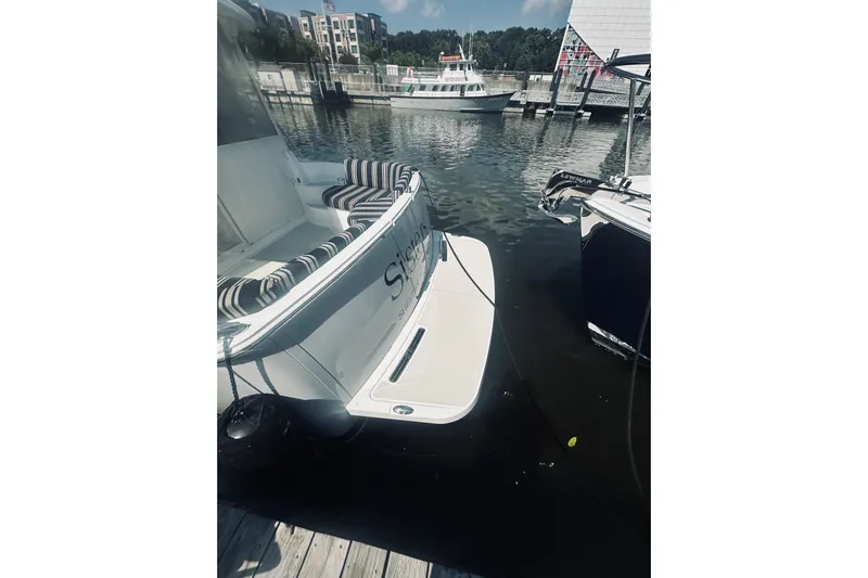 Sister's Yacht Photos Pics 2013 Back Cove 30 boat docked at marina with striped seating.