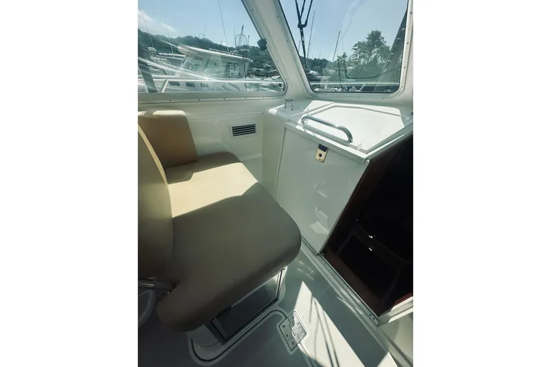 Sister's Yacht Photos Pics Interior of 2013 Back Cove 30 boat with beige seating and window view.