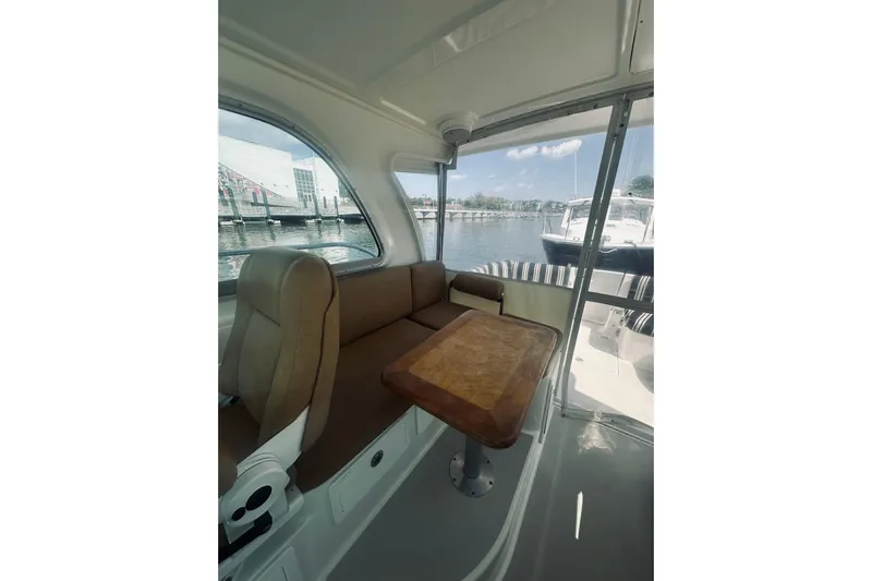 Sister's Yacht Photos Pics Interior view of 2013 Back Cove 30 boat with seating and table by the water.