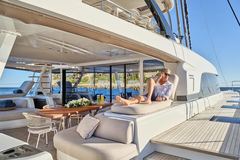  Yacht Photos Pics Luxurious 2023 Lagoon Seventy 7 yacht with elegant outdoor seating and scenic ocean view.