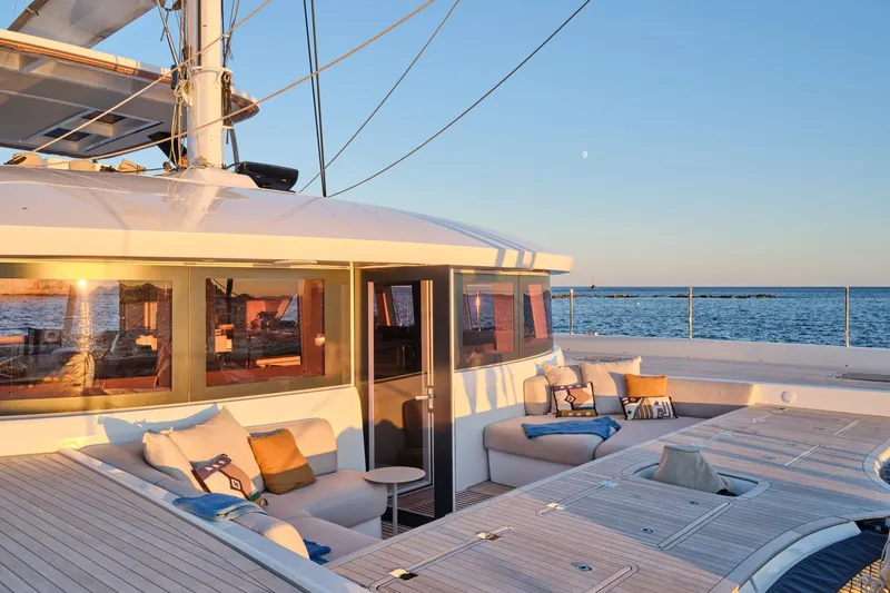  Yacht Photos Pics Luxurious 2023 Lagoon Seventy 7 yacht deck with ocean view at sunset.