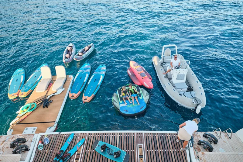  Yacht Photos Pics Water activities setup on Lagoon Seventy 7 yacht, featuring kayaks, paddleboards, and inflatable toys.