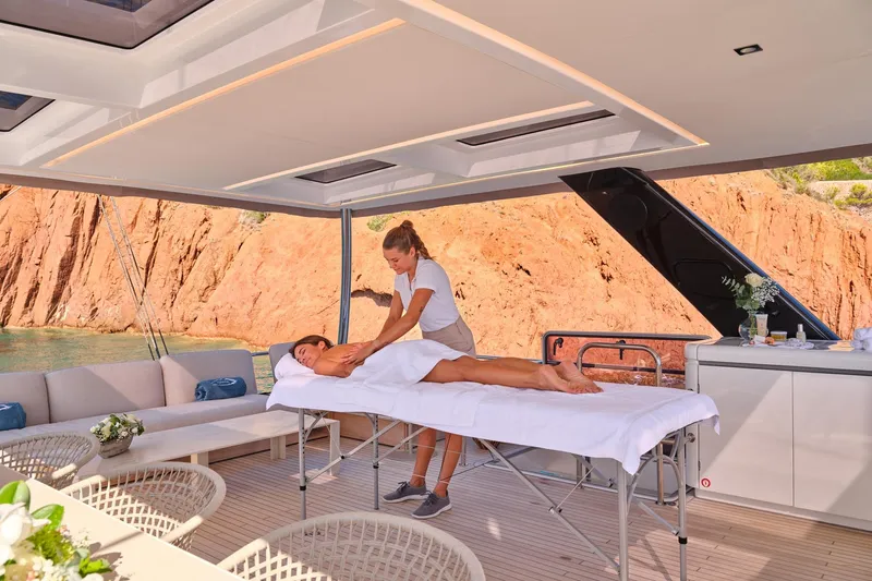  Yacht Photos Pics Massage session on 2023 Lagoon Seventy 7 yacht with scenic ocean view.
